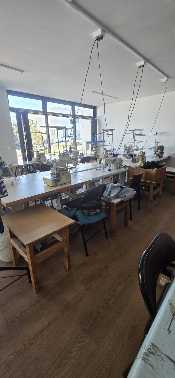 Industrial sewing machines arranged in a clothing workshop