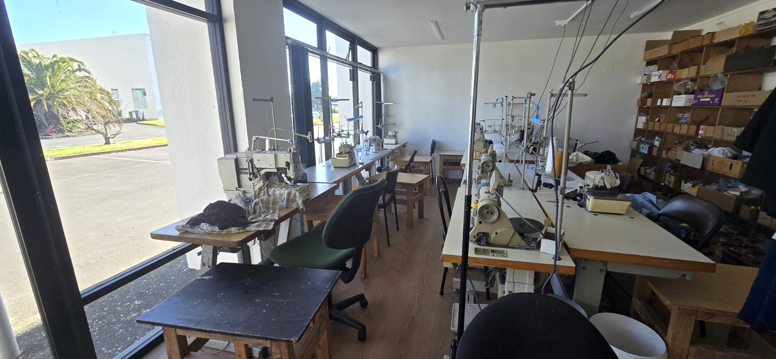 Rows of industrial sewing machines in the workshop